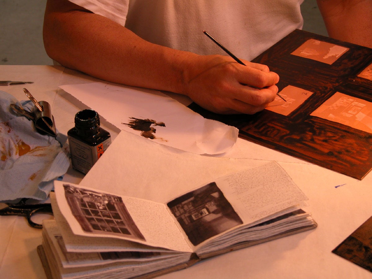 Photograph of the artist working on an aquatint plate image