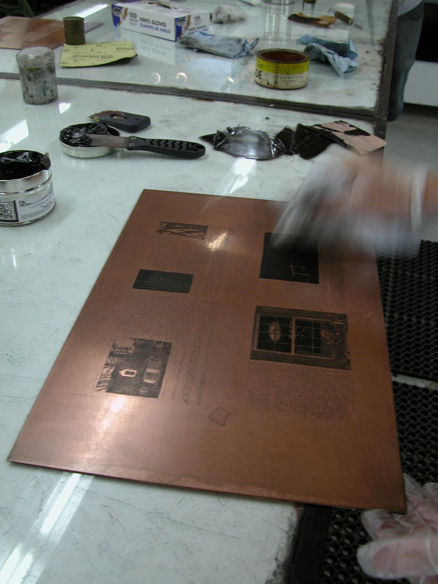 Photograph of plate being inked for printing image